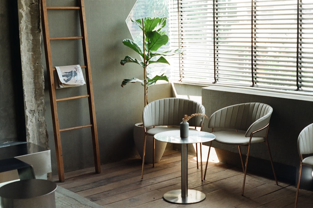 white round table with four white chairs