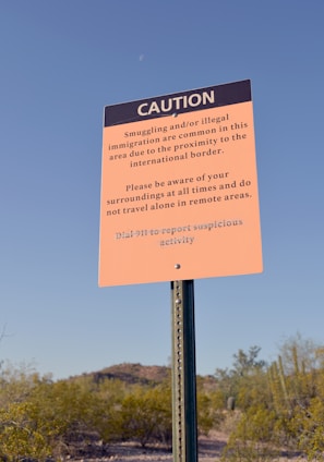 a caution sign in the middle of a desert