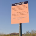 a caution sign in the middle of a desert