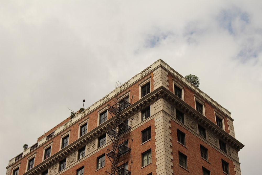 brown concrete building under white clouds during daytime