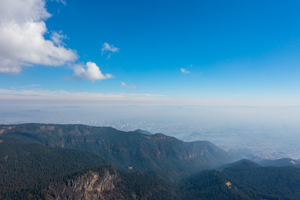 aerial view of mountains under blue sky during daytime