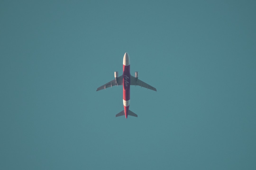 white and red airplane in flight,