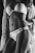 A grayscale photo features a woman wearing lace lingerie, accentuated with intricate patterns. She is posed with a hand on her hip and a draped, textured shawl over her shoulder, highlighting the curves and details of the design.