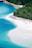 A stunning beach with clear turquoise waters and white sand.