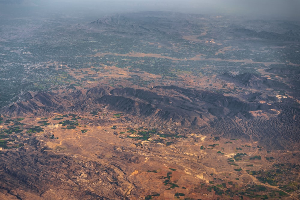 aerial view of brown and green mountains during daytime
