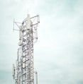 gray metal tower under white sky