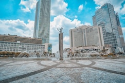 people walking on park near high rise buildings during daytime