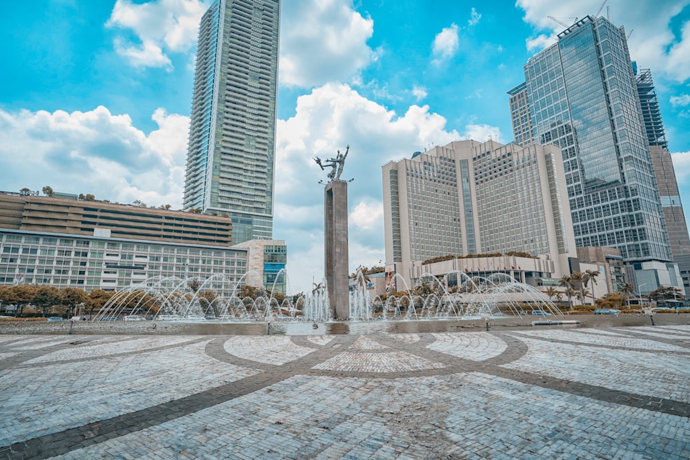 people walking on park near high rise buildings during daytime