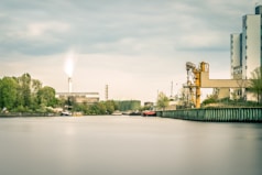 body of water near green trees during daytime