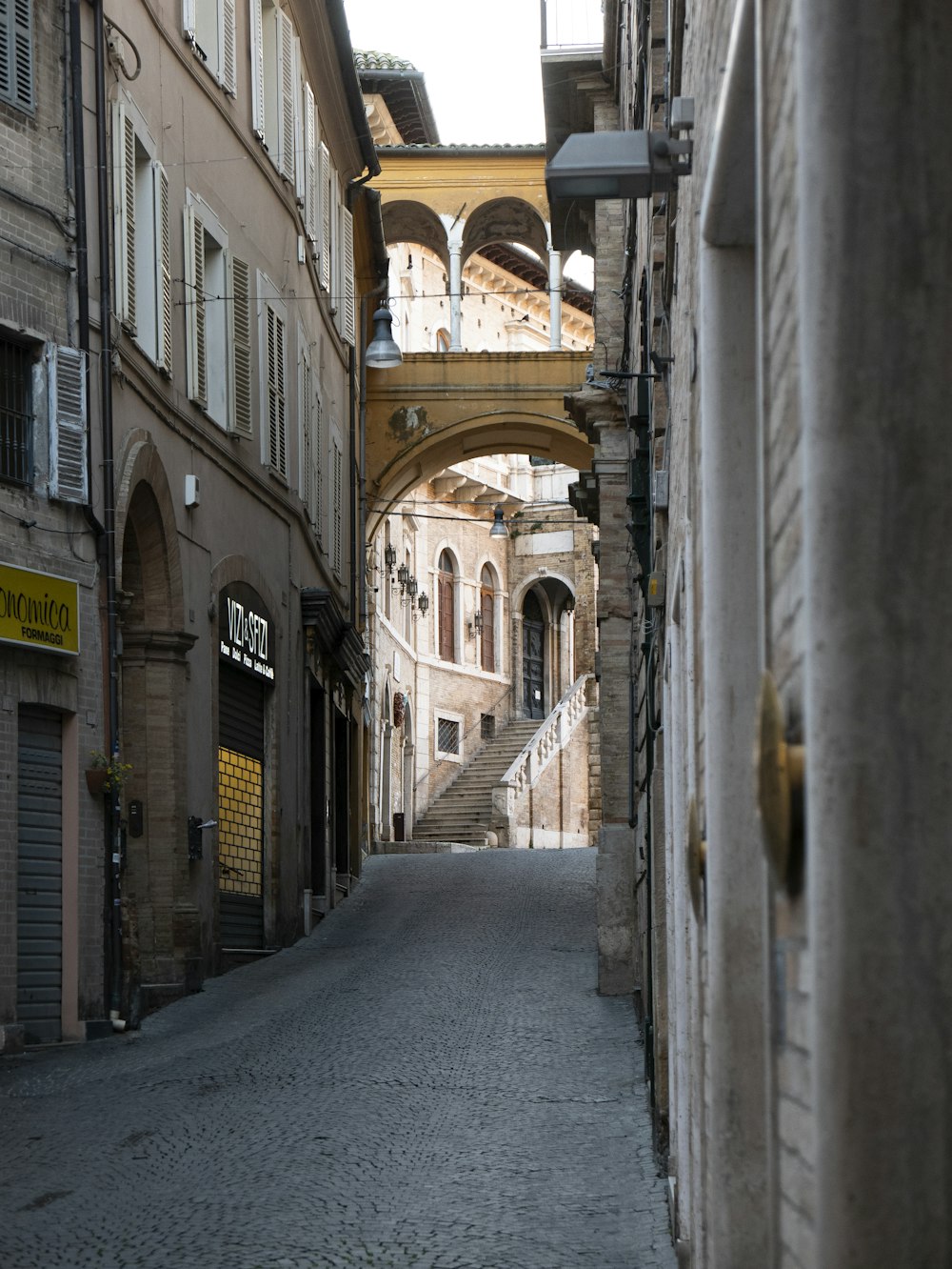 empty hallway between concrete buildings during daytime