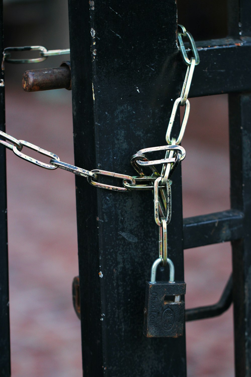 silver chain on black metal fence