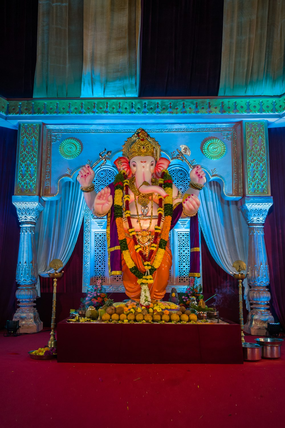 hindu deity figurine on red textile