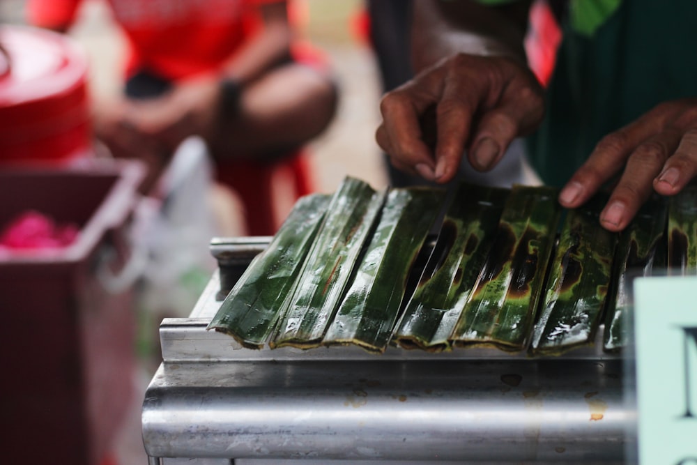 person holding green and white plastic pack