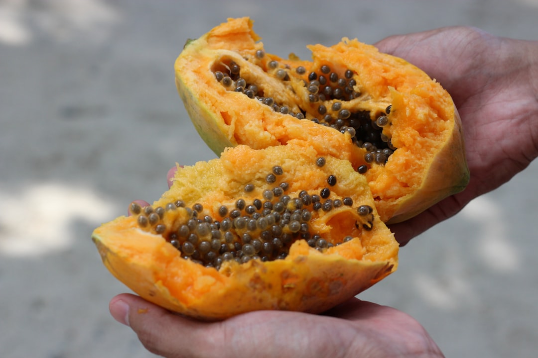 person holding yellow and black fruit,