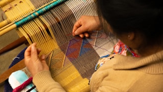 Close-up of an artisan weaving colorful threads into an intricate traditional Indian textile.
