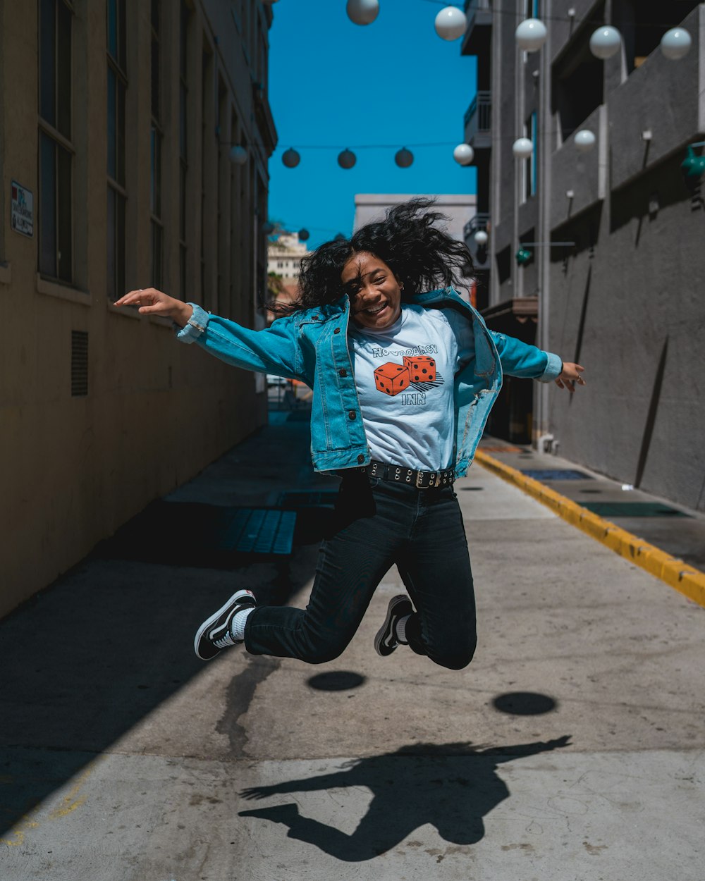 a person jumping in the air on a sidewalk