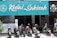 A storefront with a teal sign that reads 'Kedai Sakinah.' Several motorcycles are parked in front of the establishment. To the right of the sign, there are symbols indicating that the place is halal and has food and drink offerings. The frontage includes a gate and pillars.