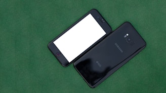 A sleek iPhone and Samsung Galaxy displayed side by side on a wooden table.