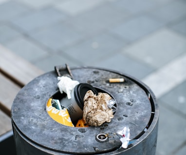 cigarette butts on black round ashtray