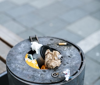 cigarette butts on black round ashtray