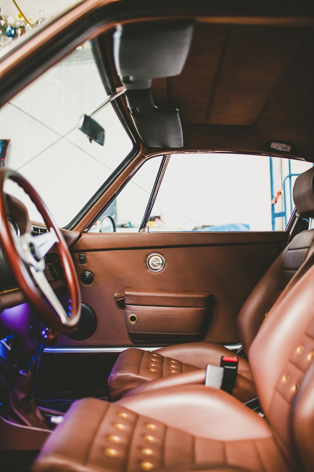 the interior of a car with brown leather seats