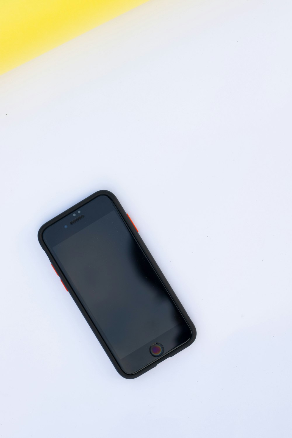 black iphone 5 on white table