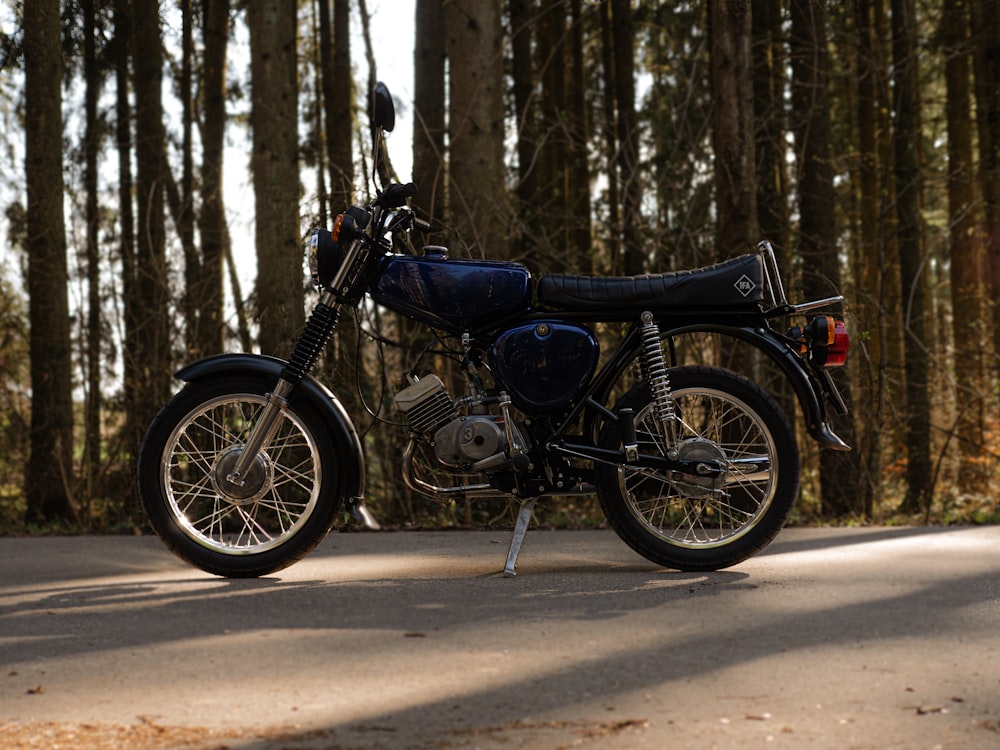 black and brown standard motorcycle parked on road during daytime