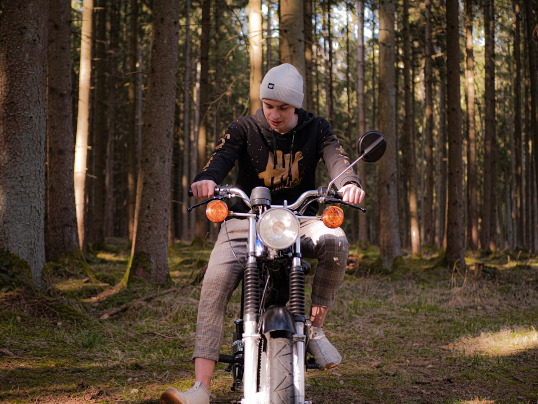 man in black jacket riding on motorcycle