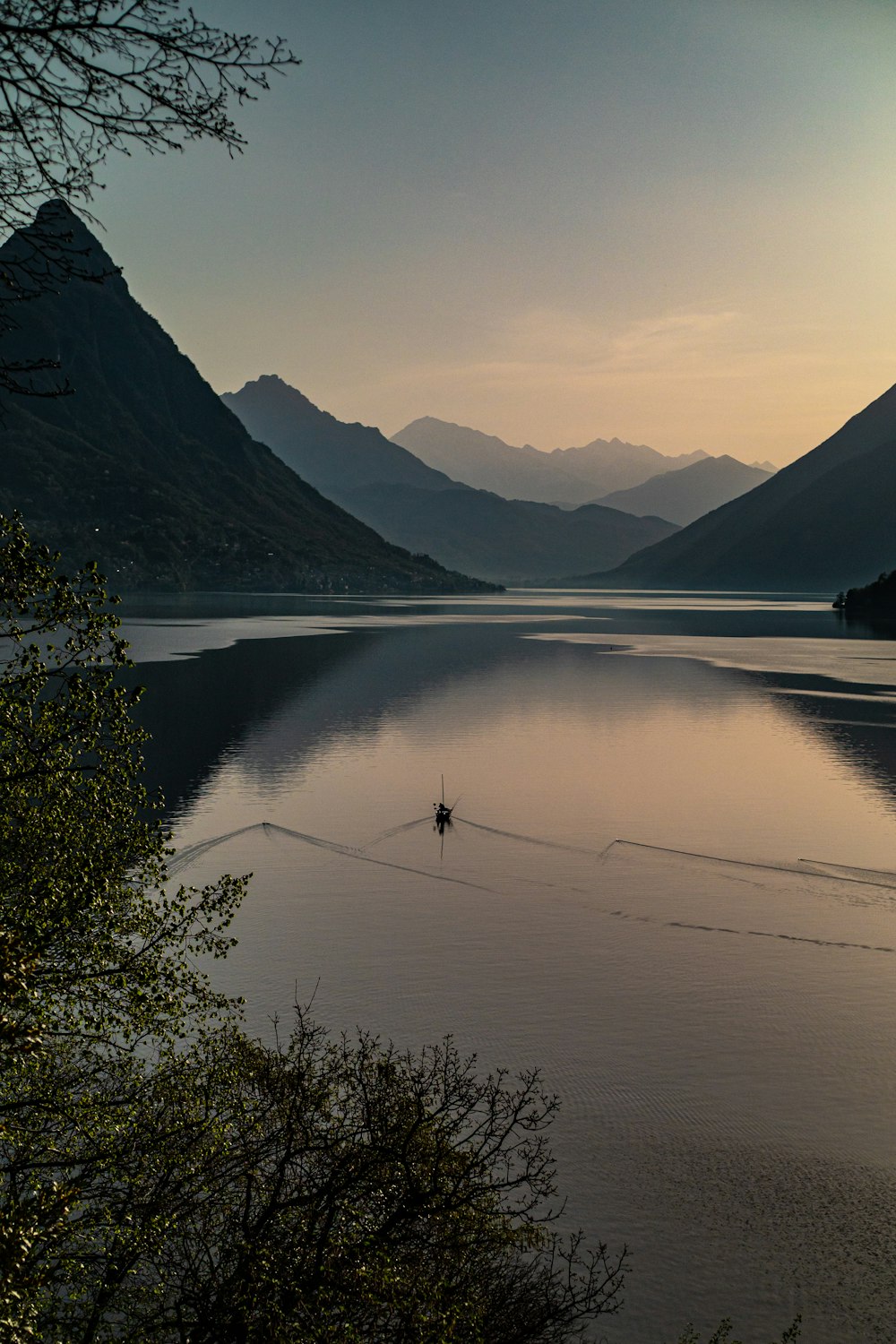 body of water near mountain during daytime