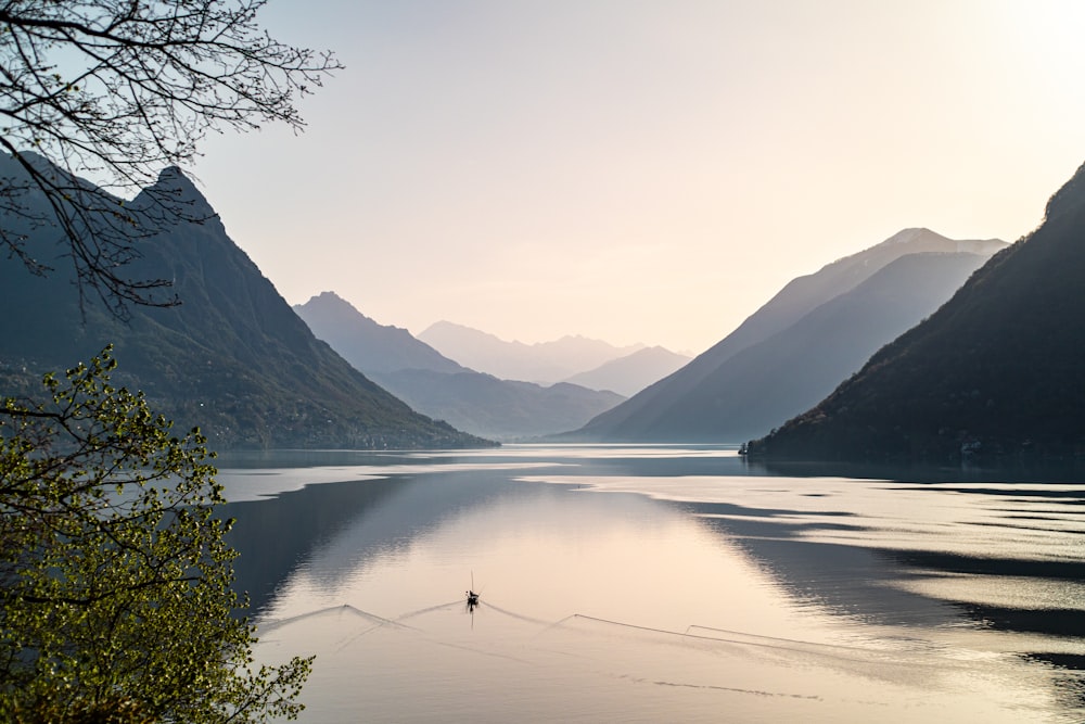 body of water near mountain during daytime