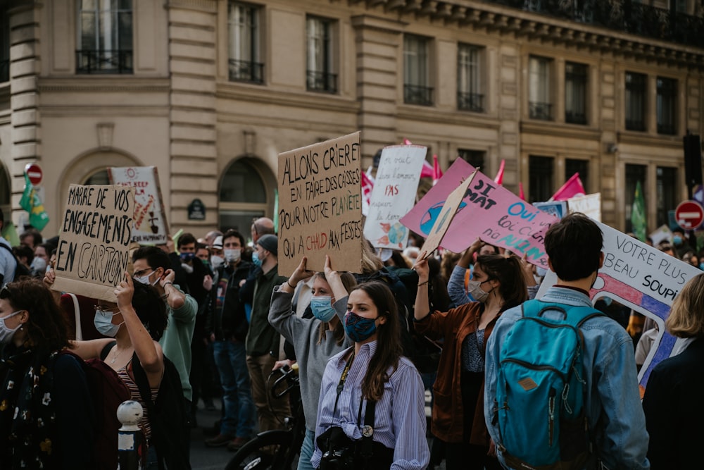 people holding banner during daytime