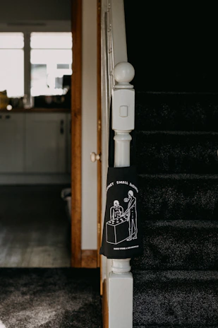 An image of a small business owner proudly standing in front of their startup shop.