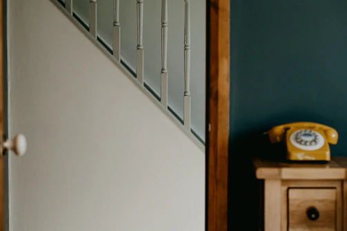 A friendly technician answering a phone call next to a sliding door.