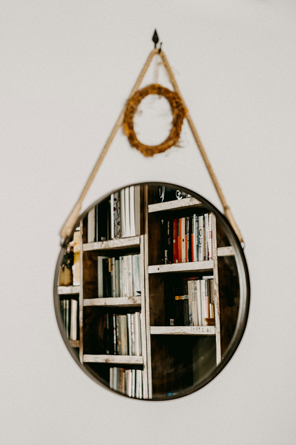 brown wooden hanging shelf with books