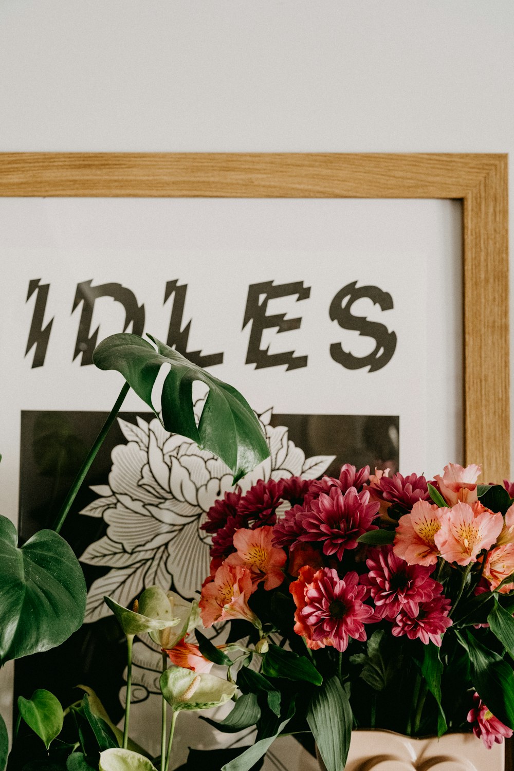 pink and red flowers on white wooden frame