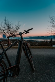 black bicycle on gray asphalt road during daytime