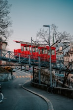 red and white concrete building near bare trees during daytime
