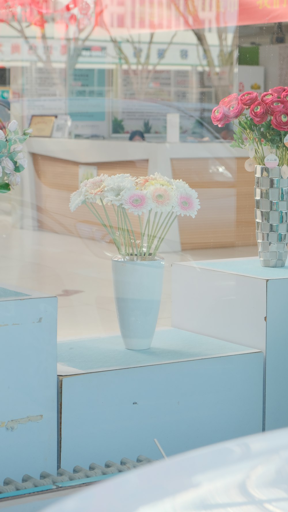 pink and white flowers in white vase