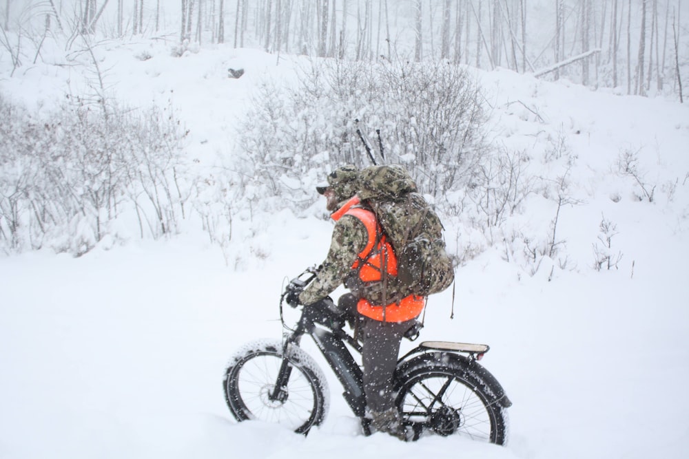 woman in brown jacket riding on black motorcycle on snow covered ground during daytime