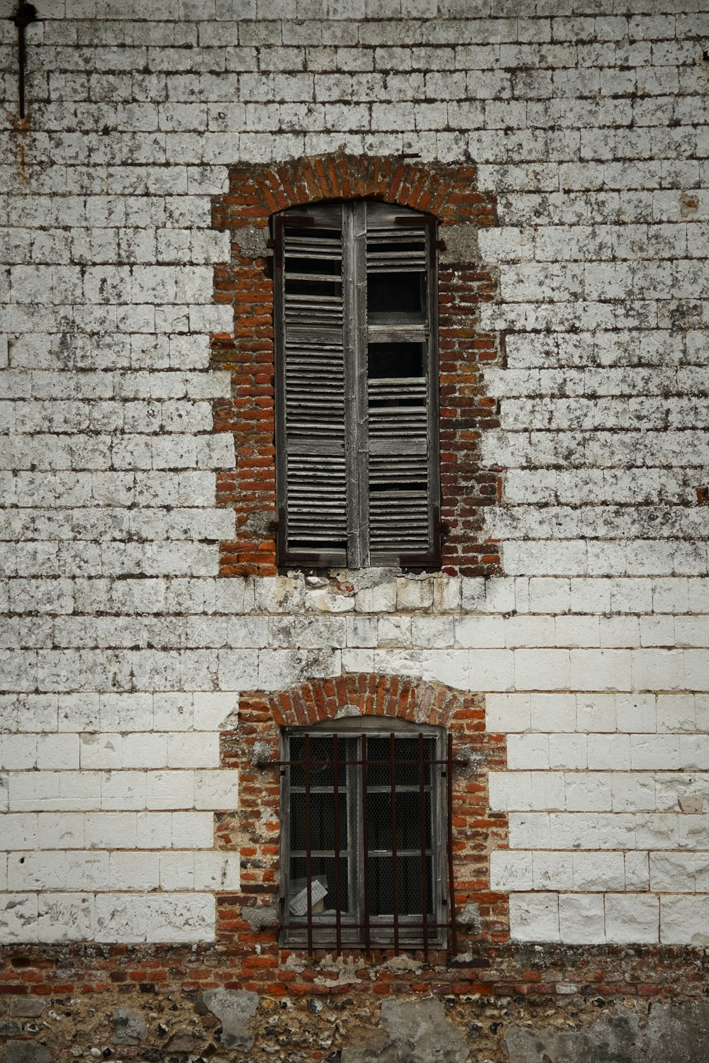 brown wooden window on white brick wall