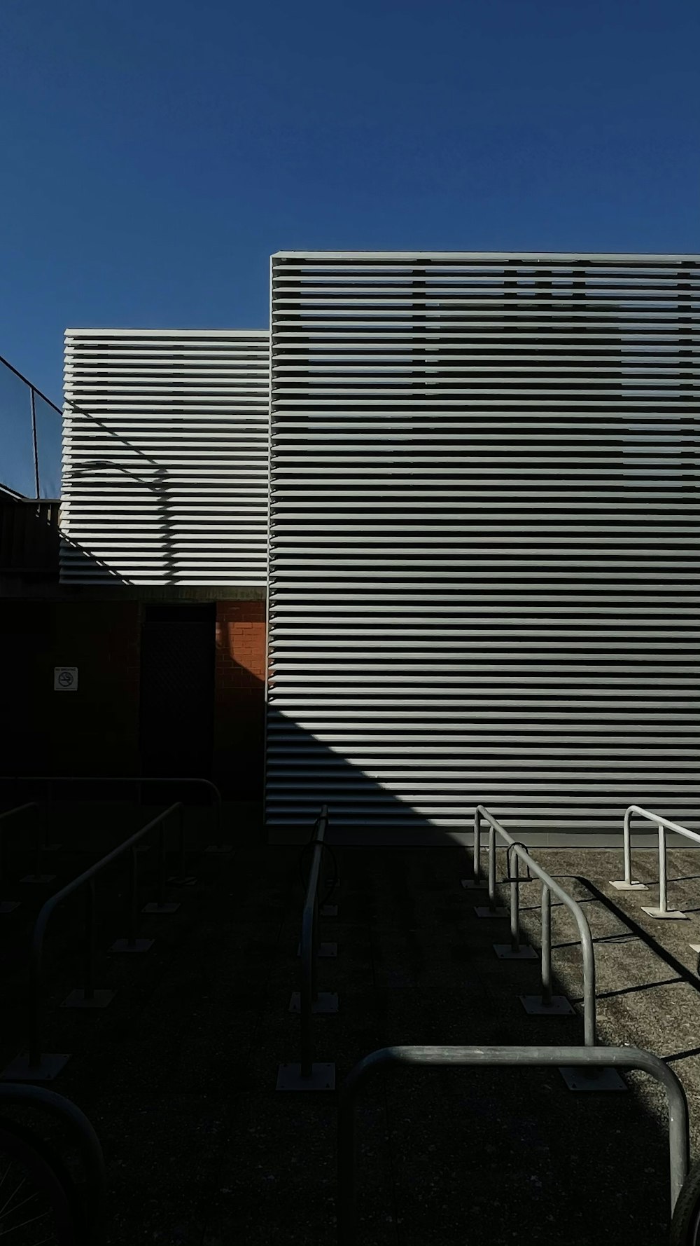 white metal railings near white and brown concrete building during daytime