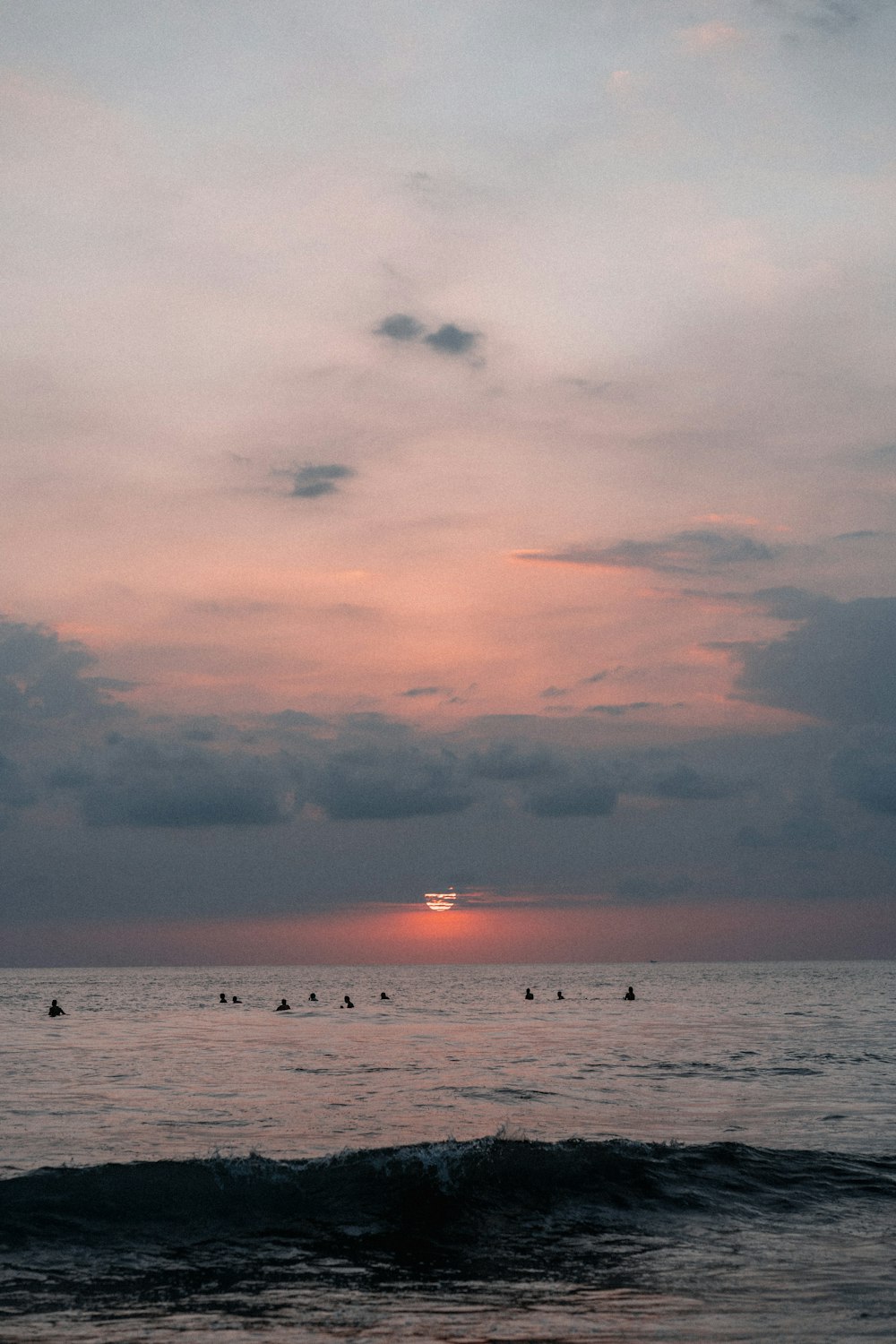 body of water under cloudy sky during sunset