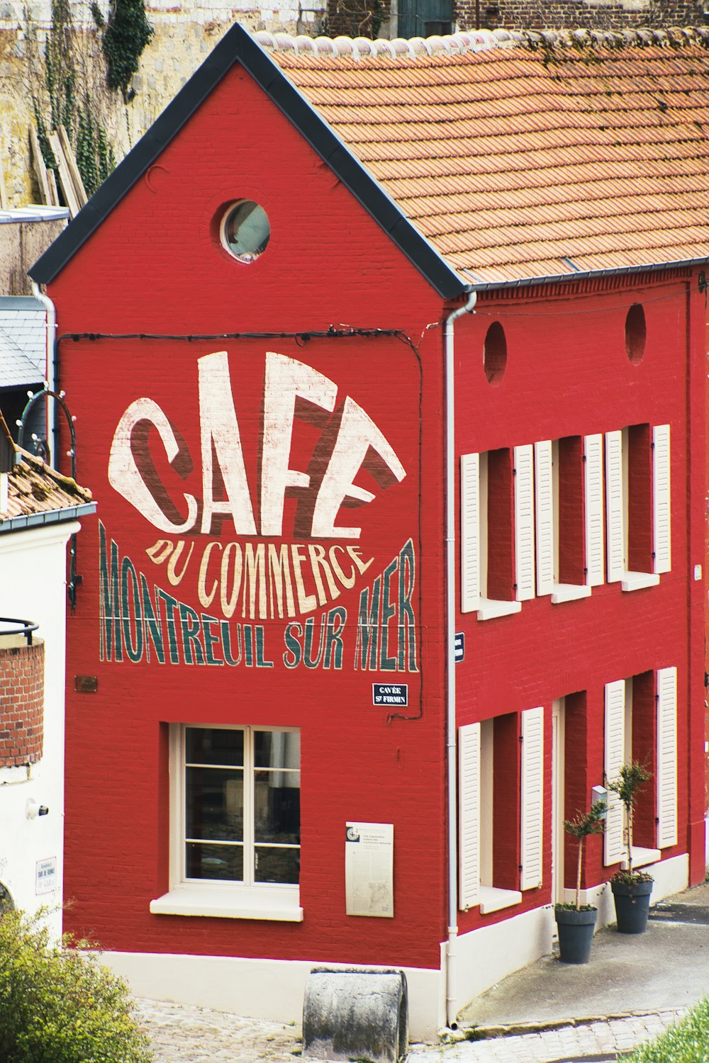 a red building with a sign on the side of it