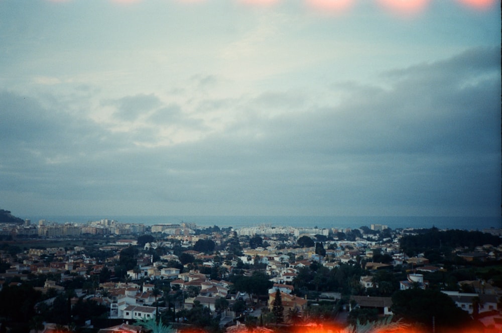 city with high rise buildings under gray sky during daytime