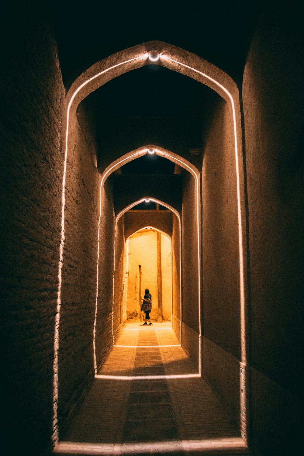 person in black jacket walking on hallway