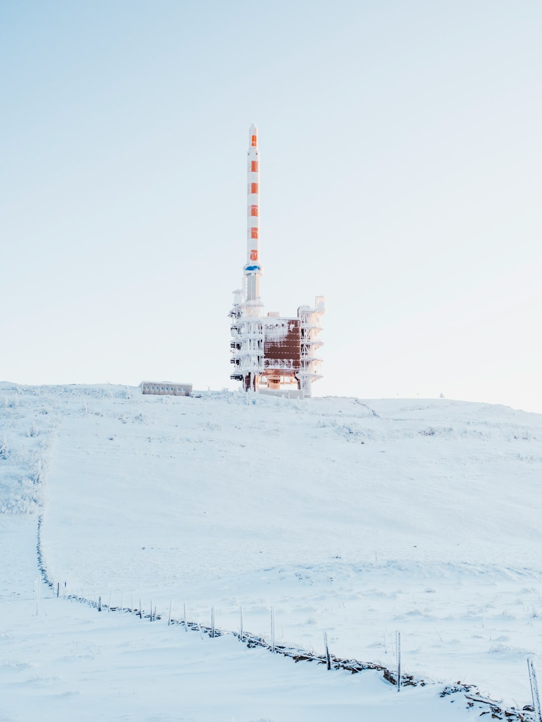 white and orange tower on white snow covered ground
