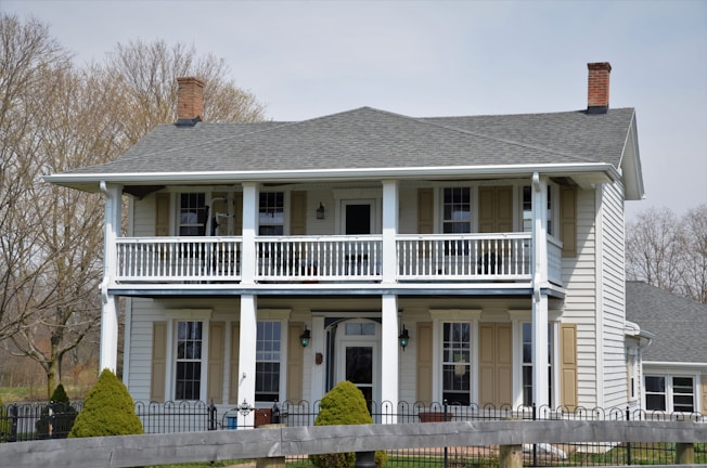 Front view of a cozy two-story house with a small garden