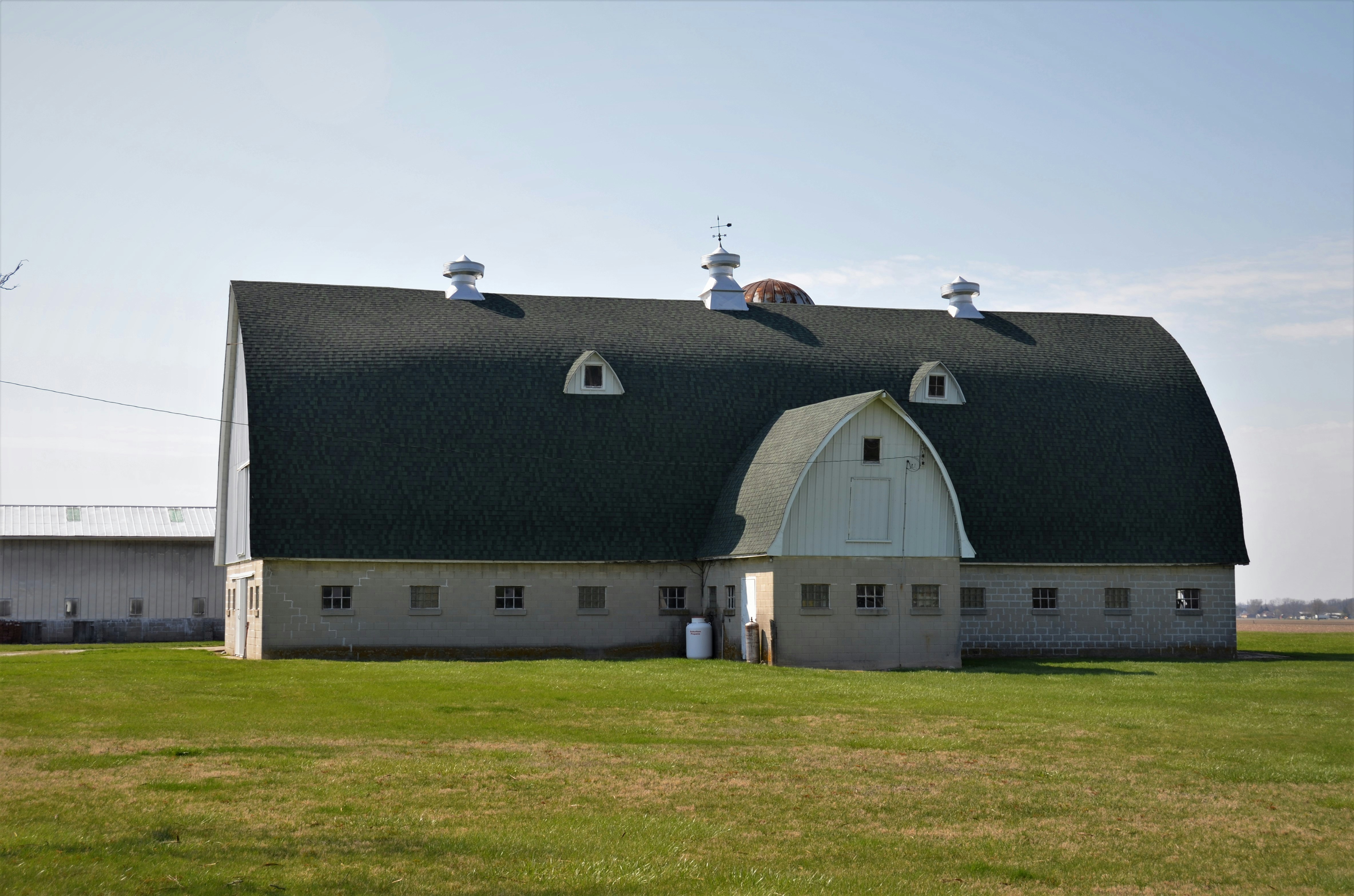 black and white house on green grass field during daytime