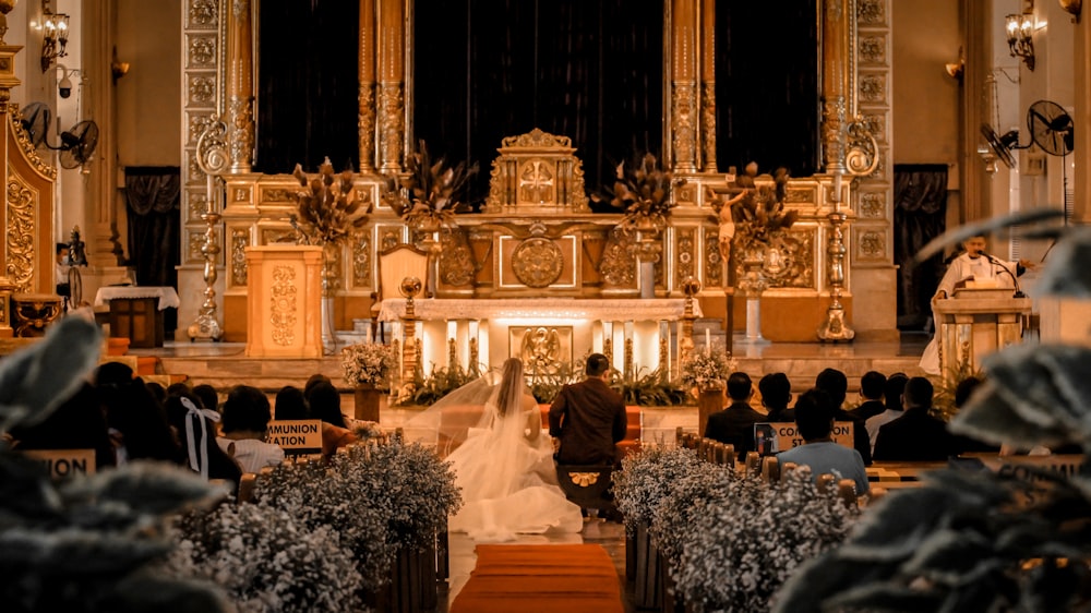 people sitting on chairs inside church