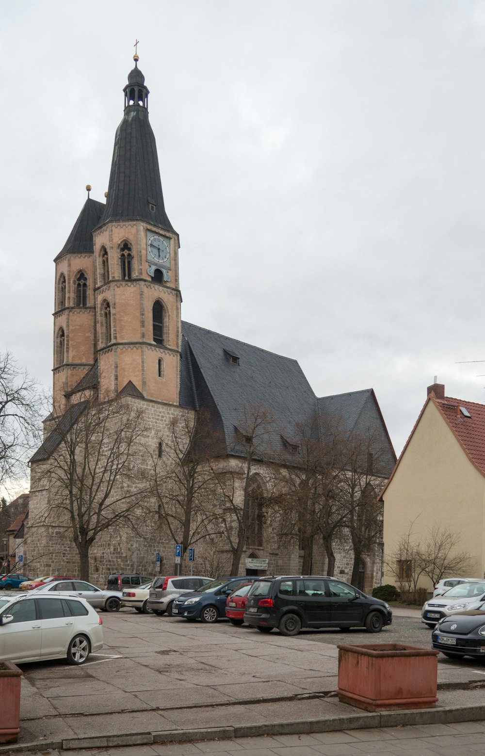 cars parked beside brown concrete building during daytime